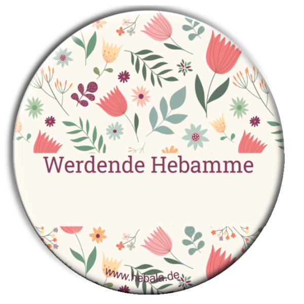 Runder Button von vorne, der mit Blumen und der Aufschrift "Werdende Hebamme" verziert ist.